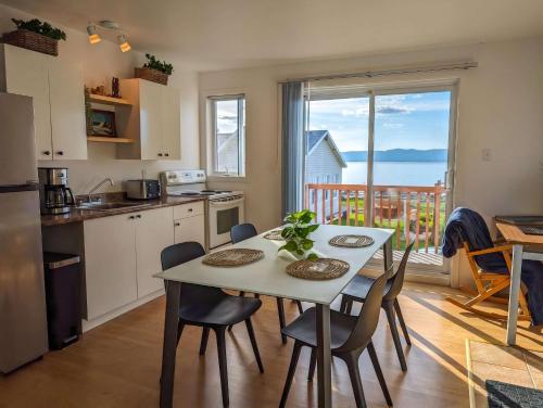a kitchen and dining room with a table and chairs at Chalet #10 - Spa & Fireplace in Cap-Saint-Ignace