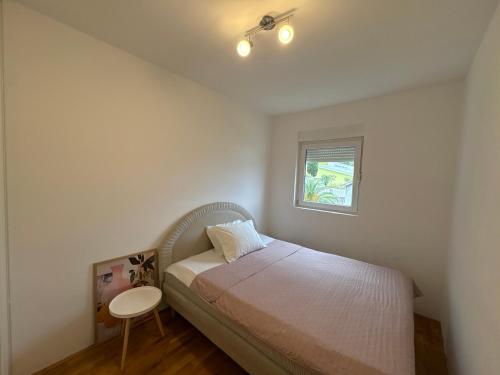 a bedroom with a bed and a small table at Boke vidik in Savina