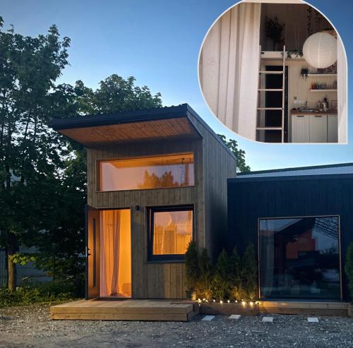 a tiny house with a large window on the side at Airport Moonlight Tallinn in Tallinn