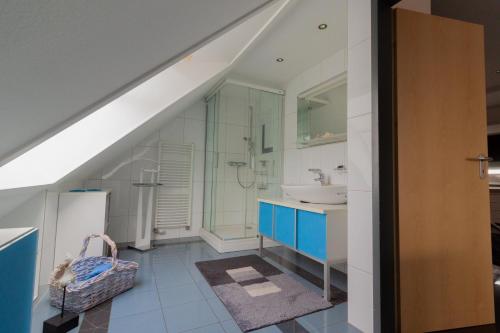 an attic bathroom with a sink and a toilet at Gästehaus am Lausitzring in Poley