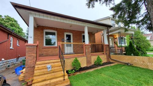 a house with a wooden fence in a yard at House - Bungalow in Hamilton