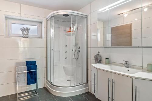 a white bathroom with a shower and a sink at Fewo Franken in Goldkronach