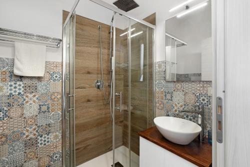 a bathroom with a sink and a glass shower at Bnb La Rocca San Vito Lo Capo in San Vito lo Capo
