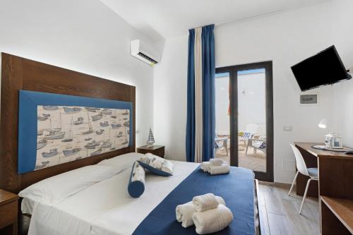 a bedroom with a bed with a teddy bear on it at Bnb La Rocca San Vito Lo Capo in San Vito lo Capo
