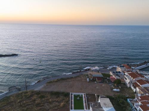 an aerial view of the ocean with a resort at MGM Suites in Panormos Rethymno