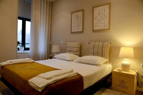 a bedroom with a large bed with two pillows at Casa Ponte de São Gonçalo in Amarante