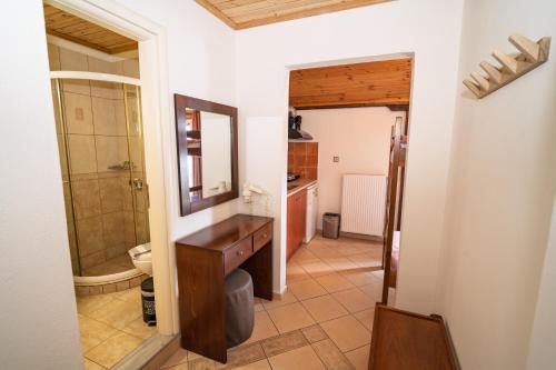 a bathroom with a sink and a mirror at ARTEMIS ROOMS in Pefki