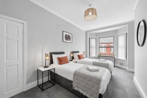 a bedroom with two beds and a window at Rockland Retreat - Near Crosby Beach & Liverpool in Waterloo