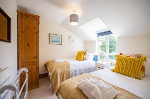a bedroom with two beds and a window at The White House, Tunstall in Tunstall
