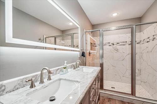 a bathroom with a sink and a shower at THE VIEW Hot Tub Fire Pit Private in McHenry