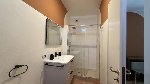 a bathroom with a white sink and a shower at B&B Villa Giuliana in Arnesano