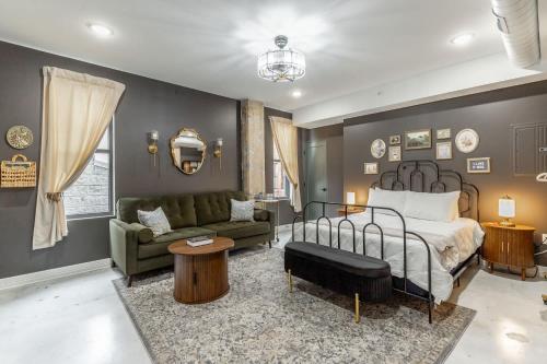 a bedroom with a bed and a couch at Park Hotel Studio Suite 311 in Chattanooga