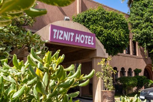 a sign for a hotel in front of a building at Tiznit Hotel in Tiznit