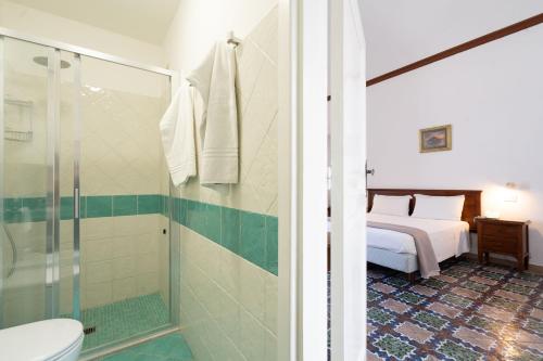 a bathroom with a bed and a shower and a toilet at Pensione Di Lustro in Forio d'Ischia