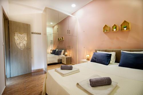a bedroom with a large white bed with blue pillows at Mpoulakis Apt 46 in Kissamos