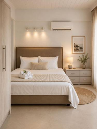a bedroom with a large bed with white pillows at PJ Properties Studio in Sounio steps away from the beach in Sounio
