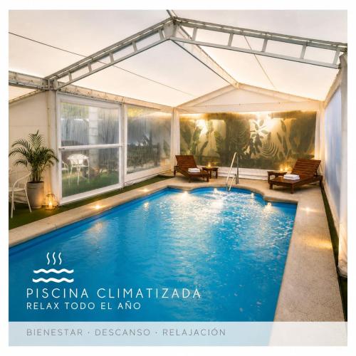 a swimming pool in a house with a marquee at Hotel Mirador de las Sierras in Villa Carlos Paz