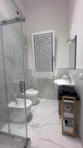 a bathroom with a toilet and a sink and a shower at Angels Venice in Marghera