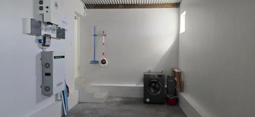 a laundry room with a washing machine in a wall at Sage & Salt in St. Helena Bay