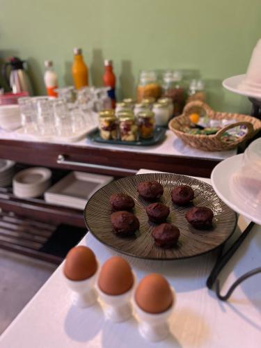 a table with a plate of muffins and eggs on it at Cape Town 4U Guesthouse in Cape Town