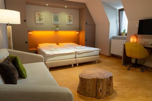a room with two beds and a tree stump in it at Penzion Nový Rybník in Obořiště