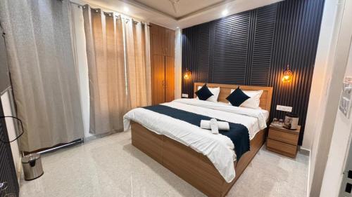 a bedroom with a large bed and a large window at Satya Avenue Dehradun, Near Pearl Paradise IT park Road in Dehradun