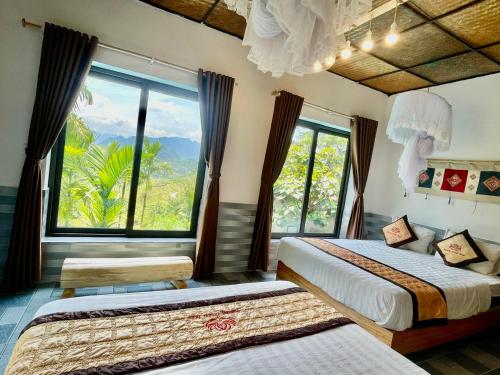 a bedroom with two beds and a large window at Puluong Aroma in Lũng Tiềm