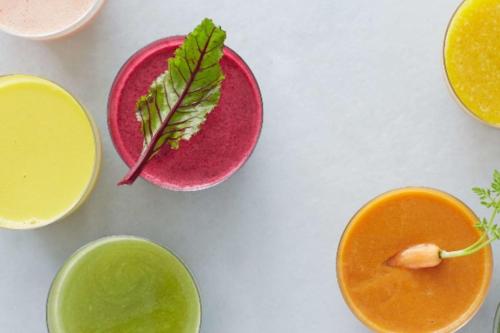a table topped with bowls of different colored liquids at COMO The Halkin in London