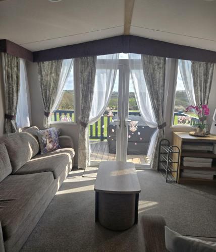 a living room with a couch and a table at 14B Medina Rise Ferry Offers Available in Porchfield