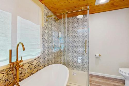 a bathroom with a shower and a toilet at Hill House in Belfair