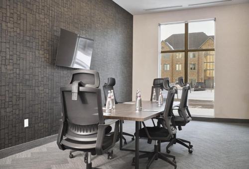 a conference room with a table and four chairs at Four Points by Sheraton Oakville in Oakville