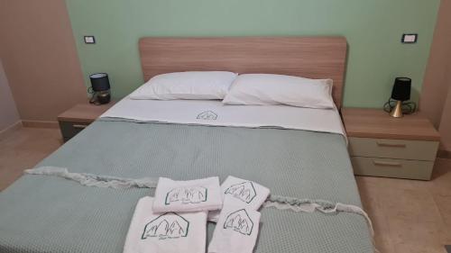 a bedroom with a bed with two towels on it at Bruner Haus - Casa Vacanze in Castelmezzano