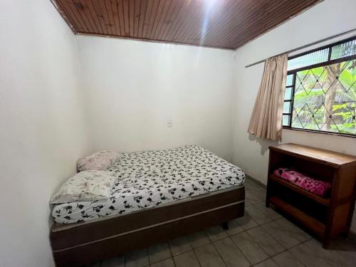 a small bedroom with a bed and a window at Hotel Montreal in Abadiânia