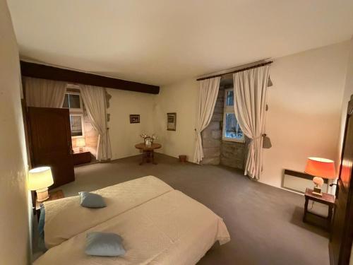 a large bedroom with two beds and two windows at Château de Savigny - Suite Eau in Savigny