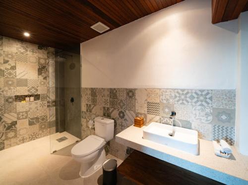 a bathroom with a toilet and a sink at Tepi Segara Seminyak in Seminyak