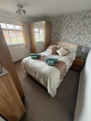 a bedroom with a large bed with two pillows on it at 16 Bentley Road - Uttoxeter, Comfortable accommodations, SHARED SHOWER ROOM, NO BREAKFAST in Uttoxeter
