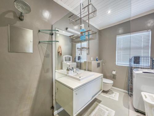 a bathroom with a sink and a toilet at 8 On Fleur Park Beach in Gordonʼs Bay