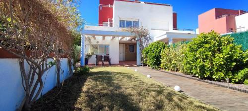 a house with a pathway leading to the front yard at Tabarca - Chalet con jardín y piscina comunitaria in Peniscola
