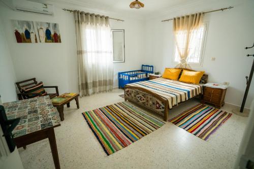 a bedroom with a bed and a rug at Villa Bianca 2 in Fafou
