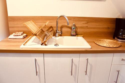 a kitchen sink with utensils on top of it at Escapade au Mont St Michel in Pleine-Fougères