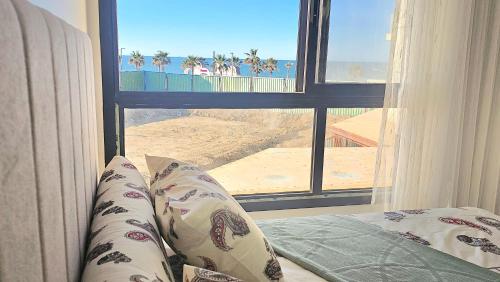 a bedroom with a view of the beach from a window at 2bed rooms chalet portosaid in Port Said