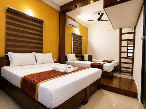 a hotel room with two beds and a ladder at Nova North Inn in Cochin