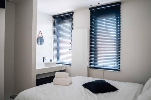 a bedroom with a bed and a sink in a room at Vakantiewoning number 44 in Ieper
