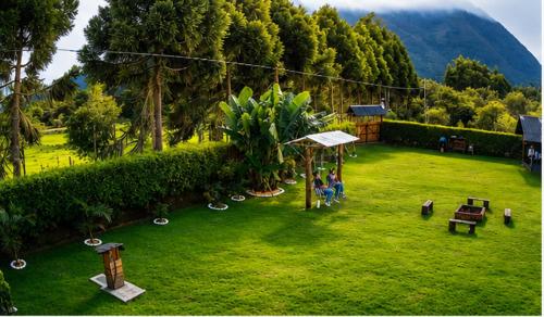 a group of people sitting in a yard at San Marcos Mountain Lodge in Chontabamba