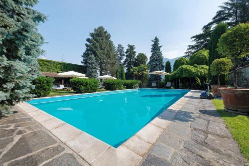 a swimming pool in the backyard of a house at Villa Wirnica Lake Como in Garlate