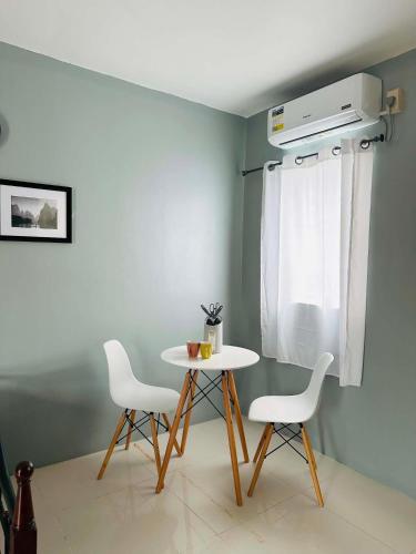 a table and two chairs in a room at ALCA Homestay in Palo