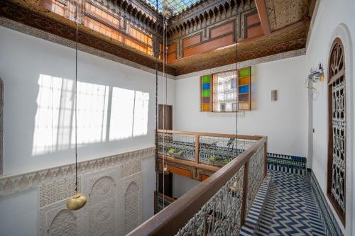 a staircase in a building with a stained glass ceiling at Riad Lik in Fez