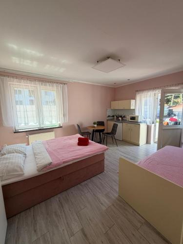 a large bedroom with two beds and a kitchen at Pokoje ALbert UL GDAŃSKA 40 in Krynica Morska