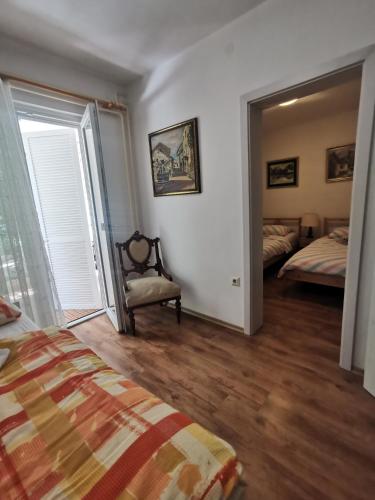 a bedroom with a bed and a chair and a window at IstraCycle in Lucija