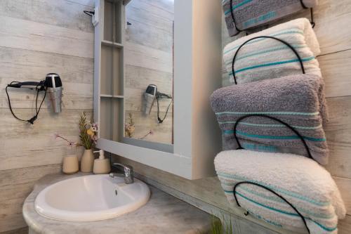 a bathroom with a sink and a towel rack at Casa do Castanheiro in Campanário